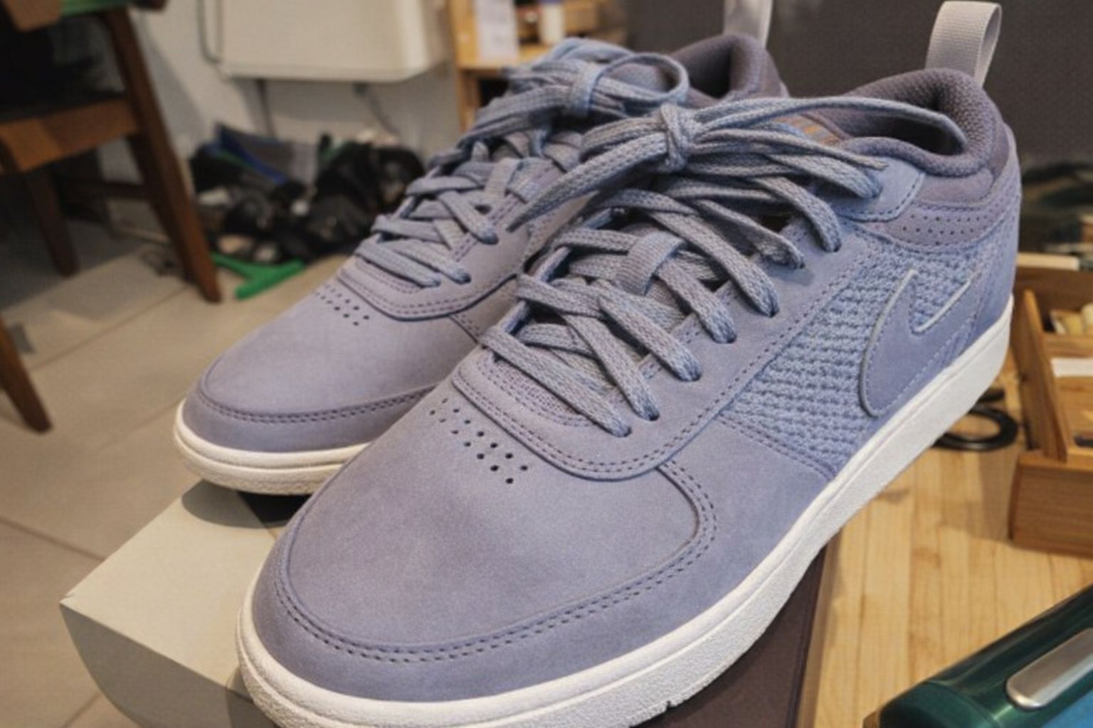 Ett par stilrena ljusblå sneakers på en skokartong.